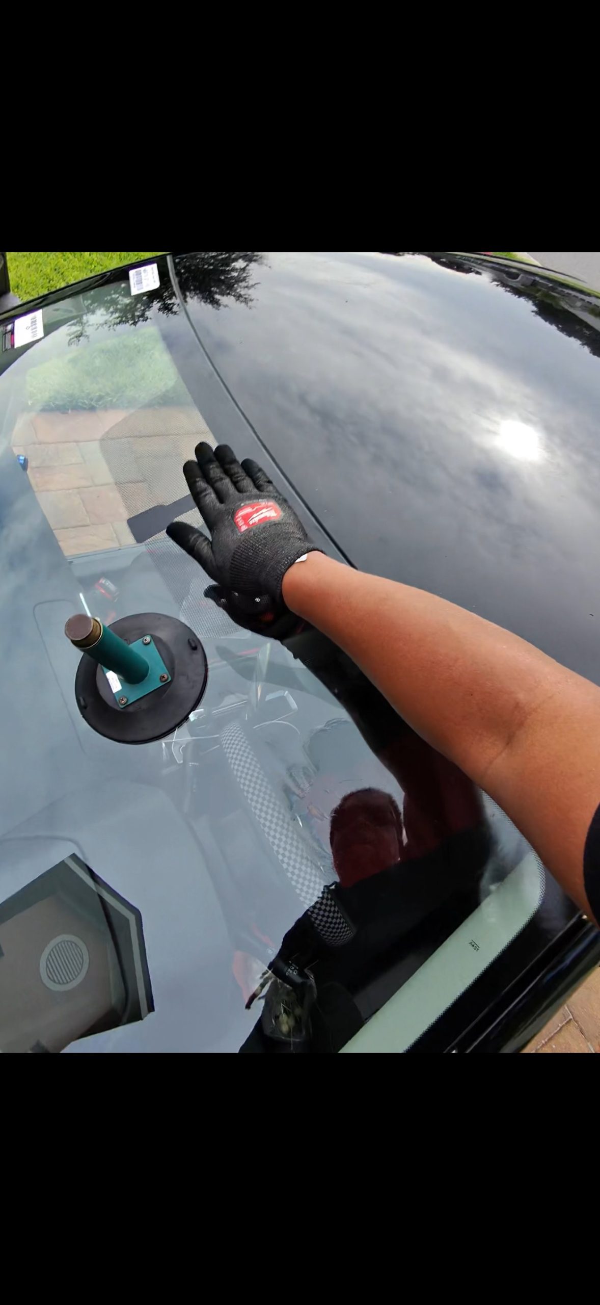 Proset Auto Glass technician setting a new front windshield at a customer location in Central Florida