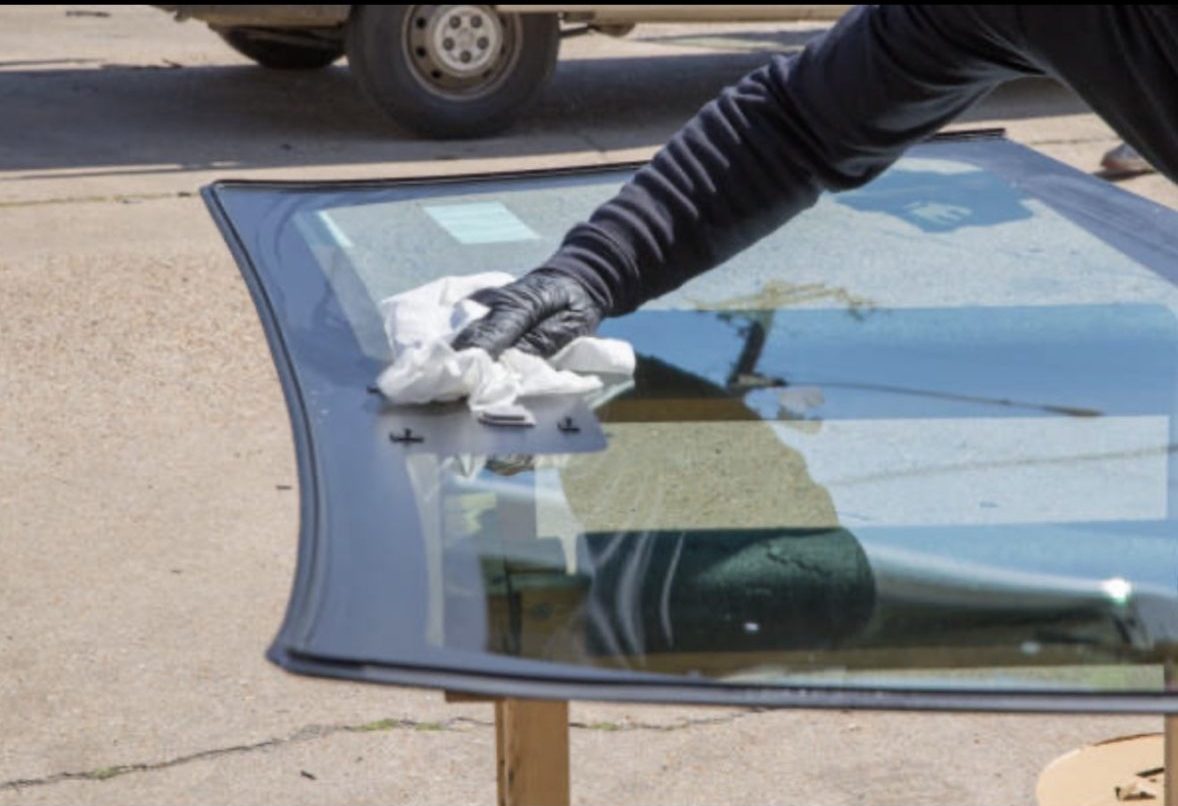 Proset Auto Glass technician cleaning front windshield before replacement
