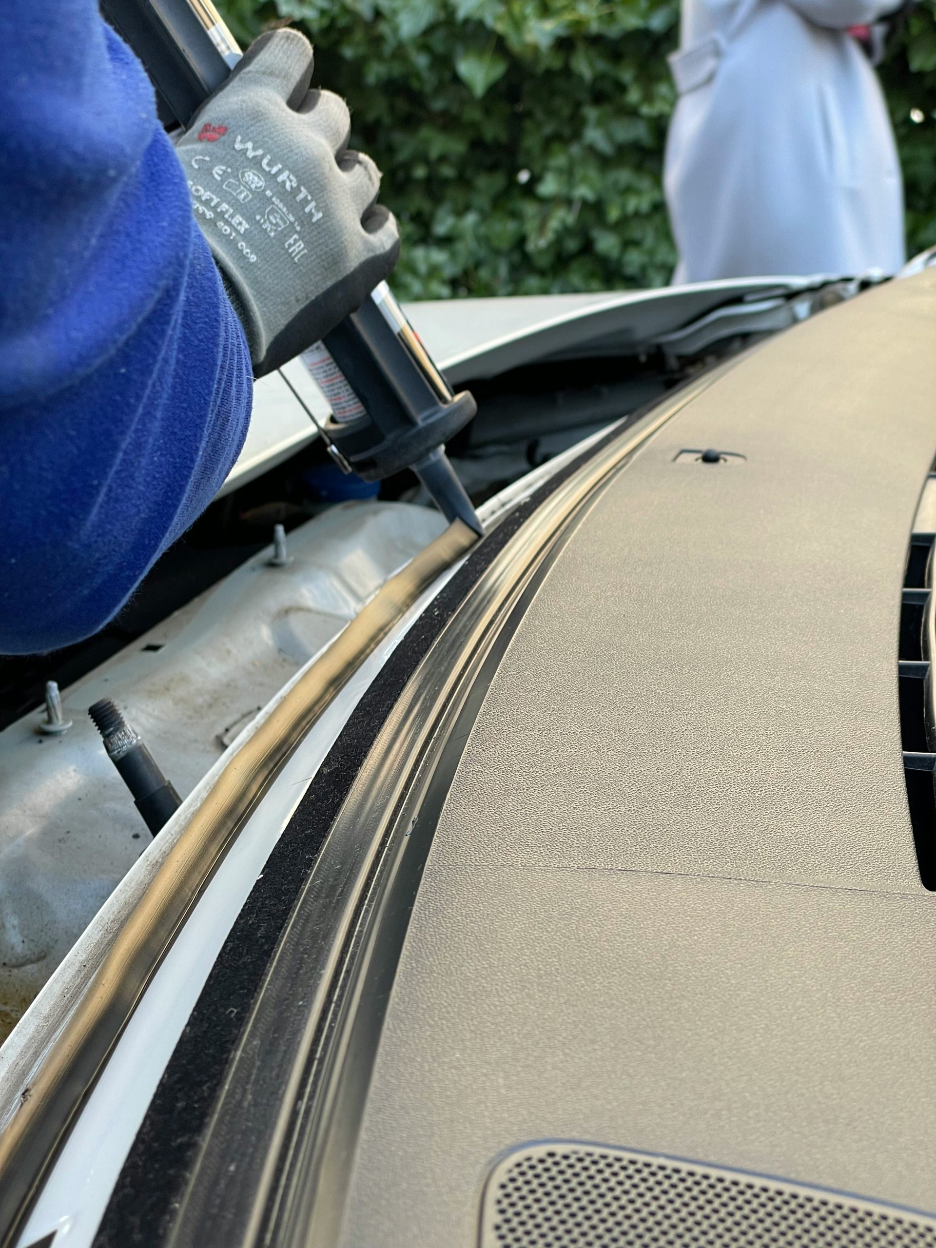 Proset technician applying urethane adhesive during windshield installation in Deltona, FL