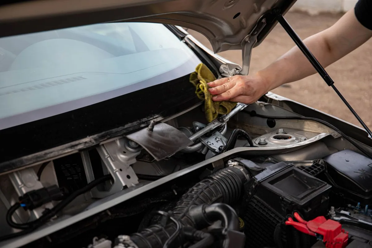 Cleaning a car windshield with a microfiber cloth during an auto glass service in DeBary, FL